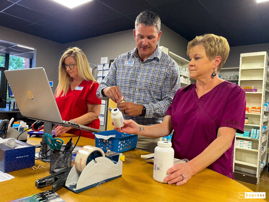 Neighbor’s Pharmacy Tech, Lynn Downing, left, and Angie Musehl, right, work with Executive Director and Pharmacist-in-Charge Henry Irvin, to fill prescriptions for patients. 